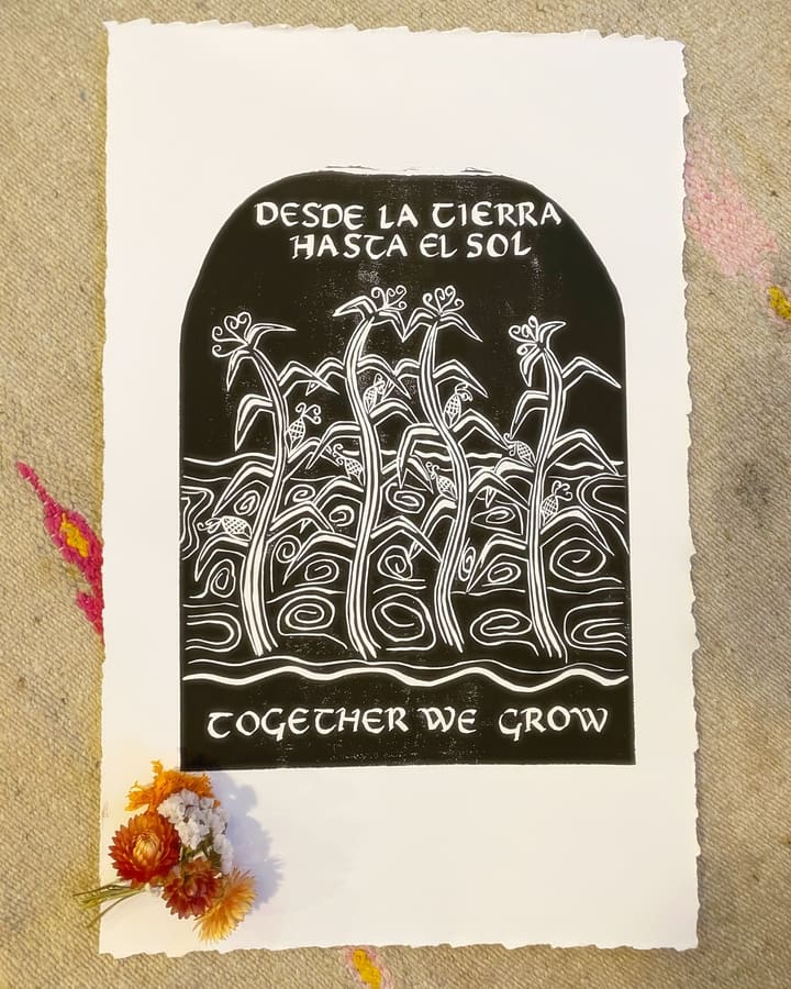 An arch-topped linocut print of tall corn stalks, reading “Desde la tierra hasta el sol,” by Palote Press.