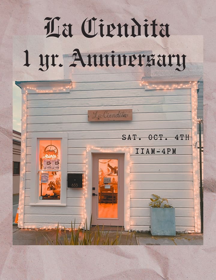 The La Ciendita storefront outlined in string lights, with a one year anniversary flyer over it.