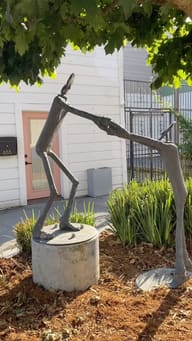 The white building at 655 9th St before the sign went up, with the bronze sculpture out front.